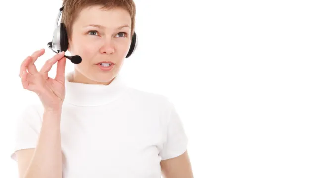 Customer service agent wearing a headset on a booking call — AI voice agents for appointment booking