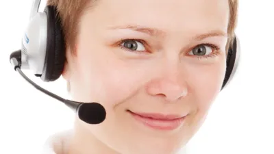 Smiling customer service woman wearing a headset, representing a support agent using reply macros