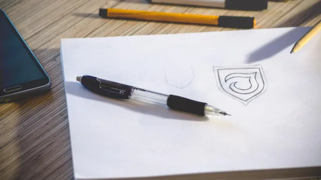 Designer sketching logo concepts on paper at a creative desk — best AI logo makers for startups