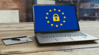 A laptop displaying the EU flag with a padlock, symbolising data protection and workplace AI policy as Sweden blocks ChatGPT Claude on government work computers.