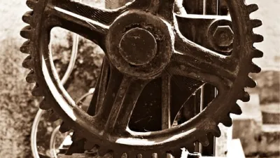 Close-up of interlocking metal gears — installing pre-built Claude Skills is like fitting ready-made gears into your workflow