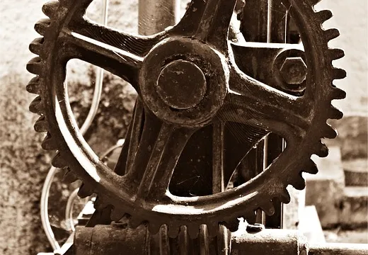 Close-up of interlocking metal gears — installing pre-built Claude Skills is like fitting ready-made gears into your workflow