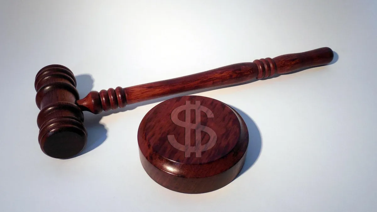 Judge's gavel and US dollar bills in a courtroom — Meta ordered to pay a $25 billion privacy penalty
