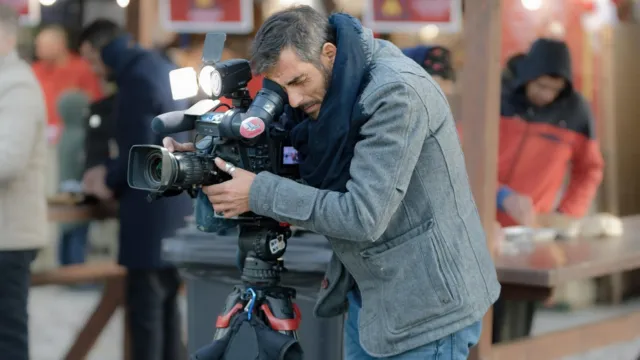 A creator recording a marketing video with a professional camera for best AI video generators for marketing