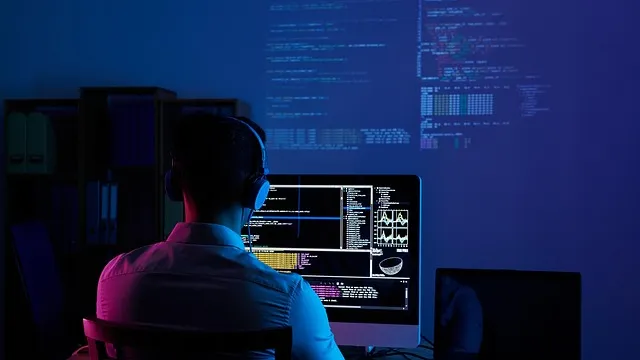 Developer using an AI coding assistant on dual monitors — Claude vs ChatGPT for coding comparison