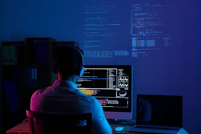 Developer using an AI coding assistant on dual monitors — Claude vs ChatGPT for coding comparison
